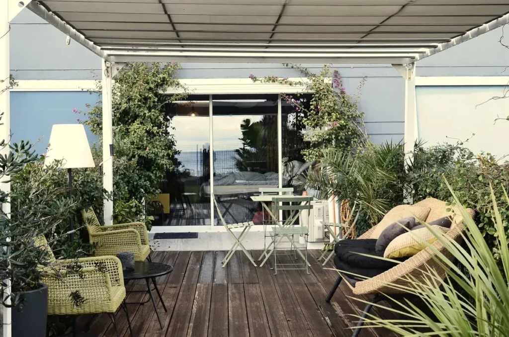 Overkapping met glazen dak aan huis in een kleine tuin